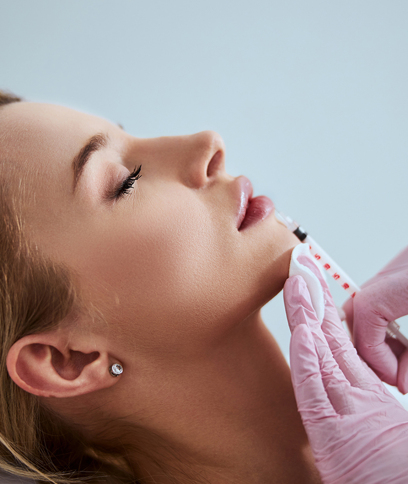 Photo of a woman getting dermal filler lip treatments