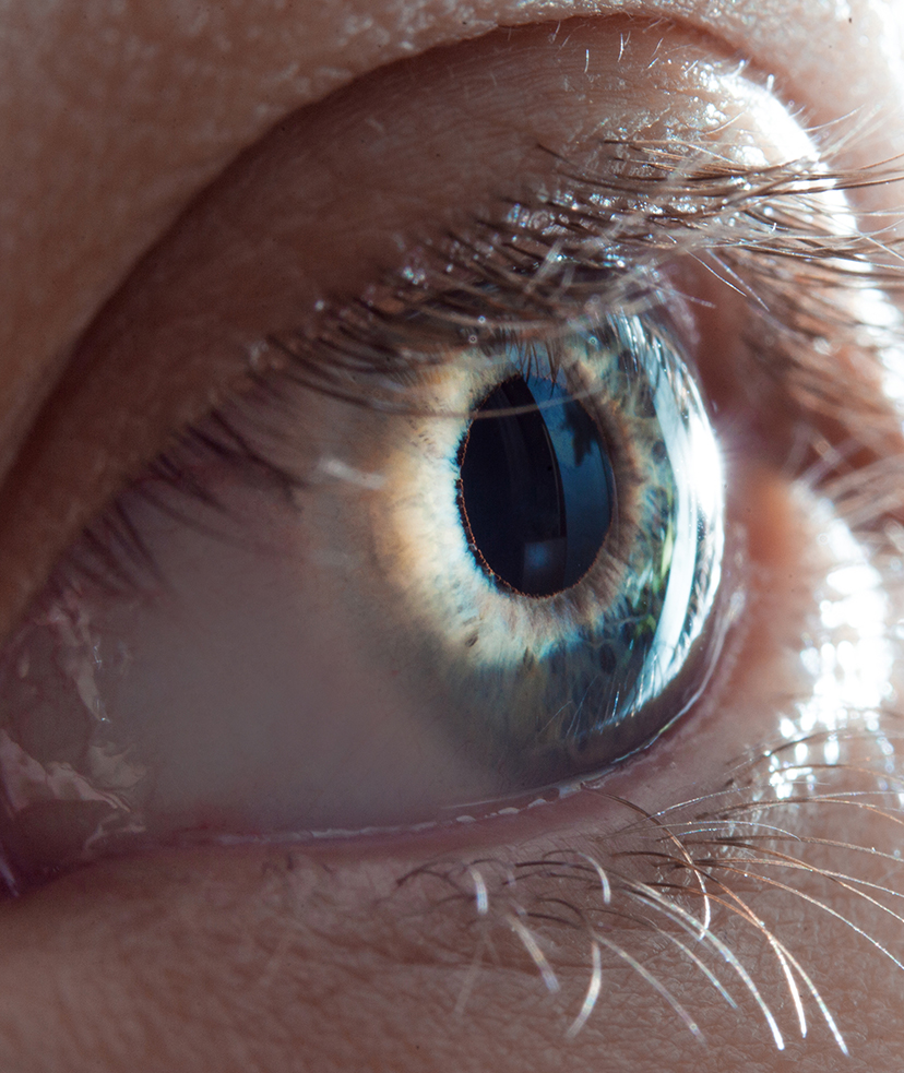 Photo of light hitting a person's blue eye