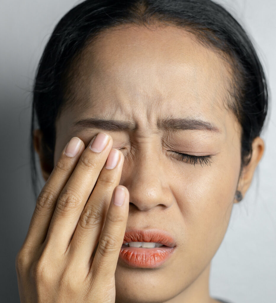 Photo of a woman rubbing her eye